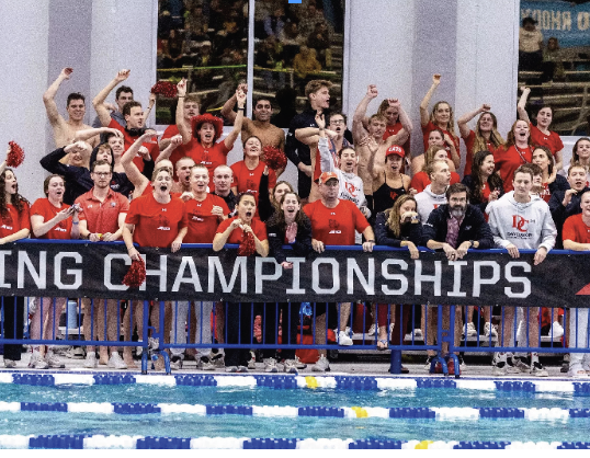 The Davidson swimming and diving teams cheer on their teammates. Photo by Davidson Athletics.