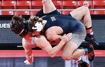 Ian McGehee ‘27 bodyslams his Belmont Abbey opponent within seconds. Photo from Davidson wrestling Instagram.