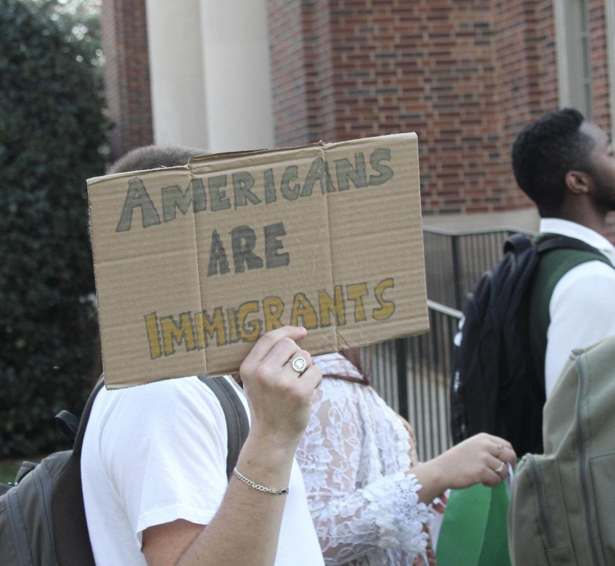 Rallygoer holds up a handmade sign at an Immigrant Justice Coalition event earlier this semester. Photo by Alex Marron ‘27.