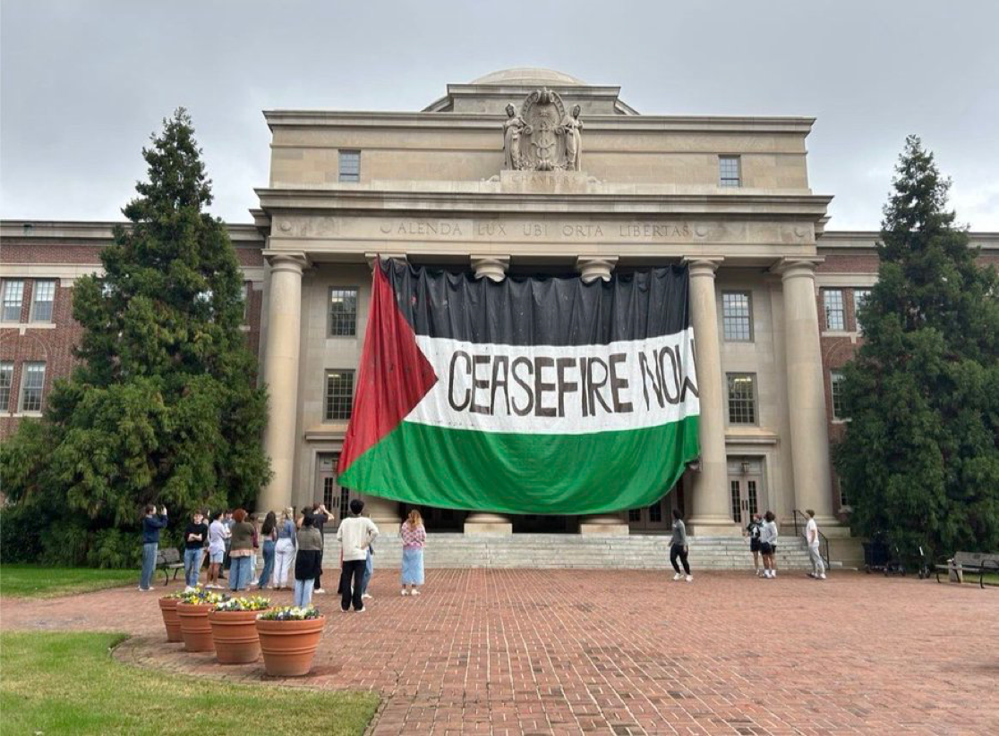 Demonstrators hung a Palestinian flag reading "ceasefire now" from the Chambers Building in spring 2024. YAF's complaint baselessly claimed demonstrators "staged a takeover." Photo courtesy of @yaf on X.