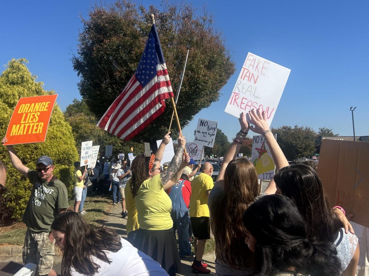 Protestors gather for a 'No Kings' protest in Cornelius on Saturday.