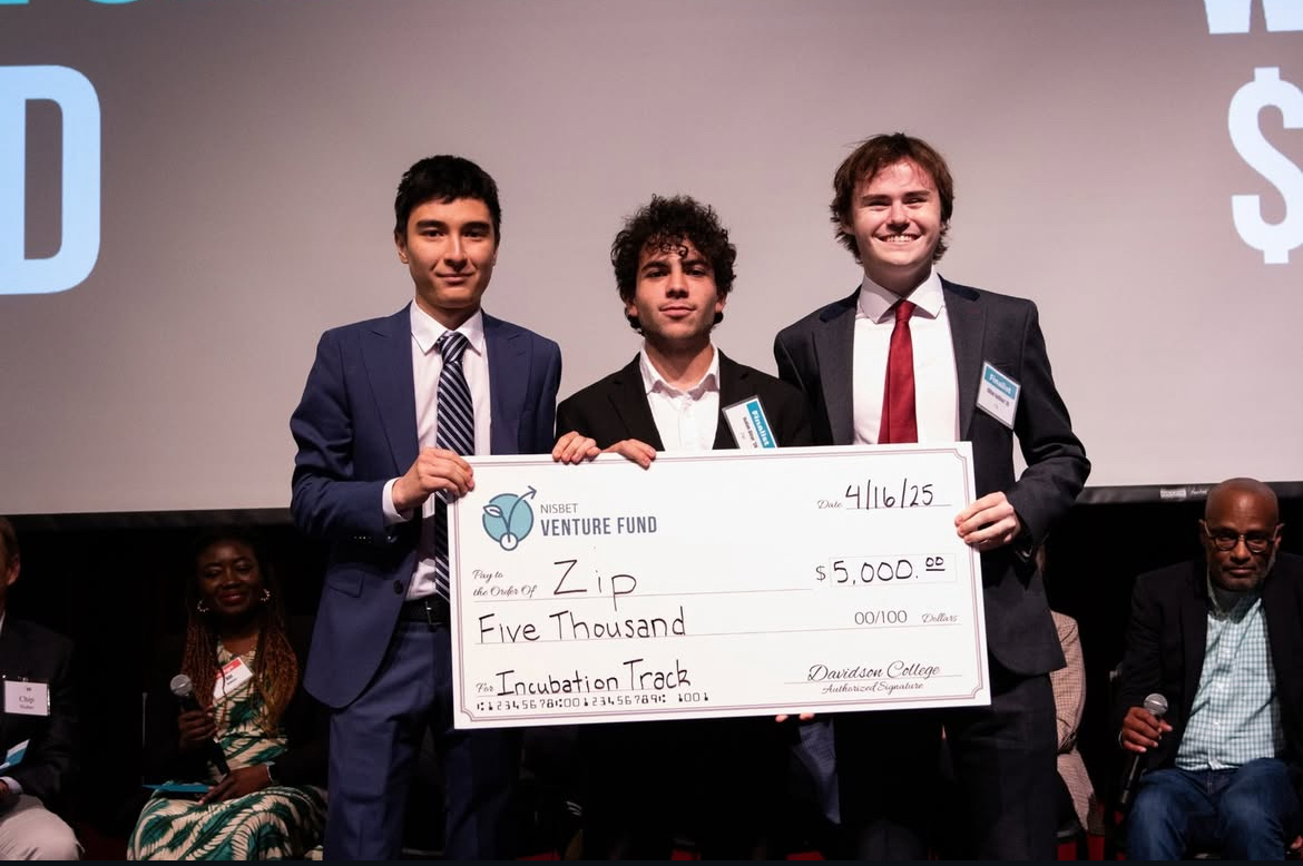 Founders stand together with Nisbet venture grant. Left to right: Daulet Berdikulov '28, Isaiah Dinar '28 and Cillian Hallinan '28. Photo courtesy of @thehurthubdavidson on Instagram.