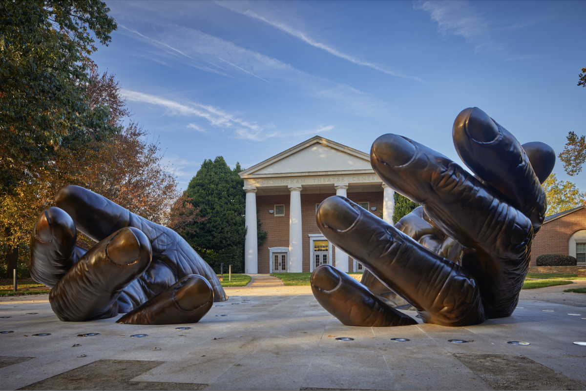 The memorial's bronze hands rest in front of the Cunningham Theatre on Davidson's Historic Quad.