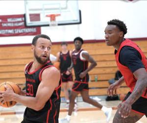 Stephen Curry matches up against Josh Scovens '27 during a Bay Area mini camp in July
