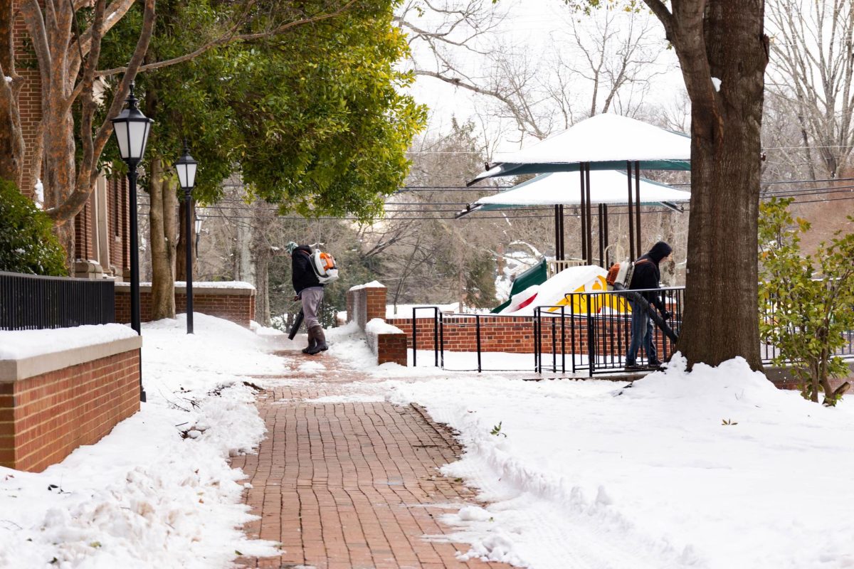 Physical plant staff used leaf blowers to clear paths near Davidson College Presbyterian Church. 