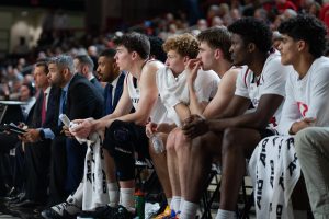 Davidson men’s basketball players sit on the bench (Left to right: Sean Logan ’26, Devin Brown, Hunter Adam ’26, JQ Roberts ’27, RJ Greer).