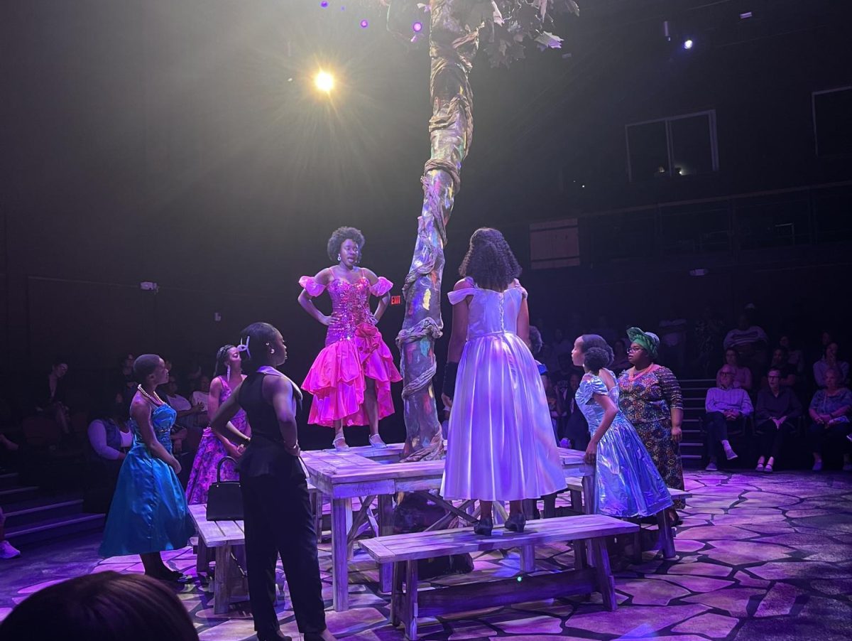 Performers on stage surround the native Ghanian tree in School Girls.  